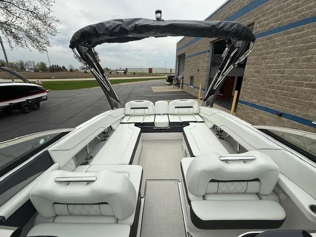 Slide: The Image of 2023 Regal LS6 boat with spacious white seating and sleek design. - 28