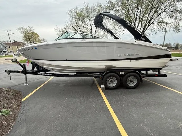 Slide: The Image of 2023 Regal LS6 boat on trailer in parking lot, side view. - 3
