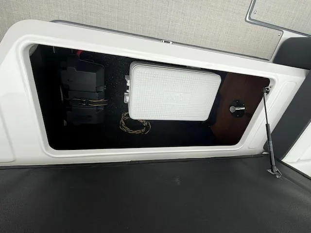 Slide: The Image of 2023 Regal LS6 storage compartment with electrical components and wiring. - 30