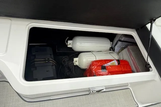Slide: The Image of Storage compartment in 2023 Regal LS6 boat with safety equipment and supplies. - 31