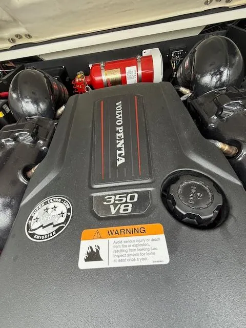 Slide: The Image of 2023 Regal LS6 engine featuring a Volvo Penta 350 V8 with safety warning label. - 34