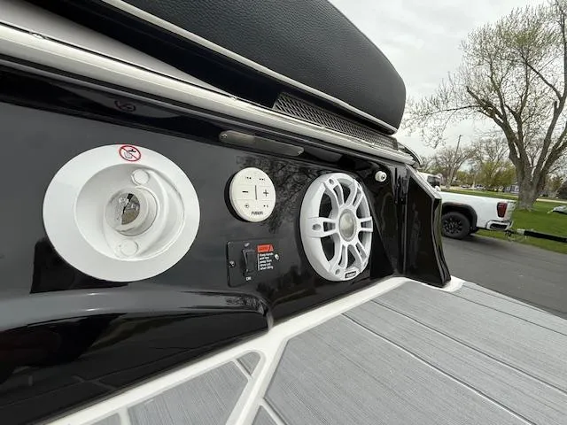 Slide: The Image of 2023 Regal LS6 boat audio system and controls on deck, featuring sleek design and modern technology. - 38