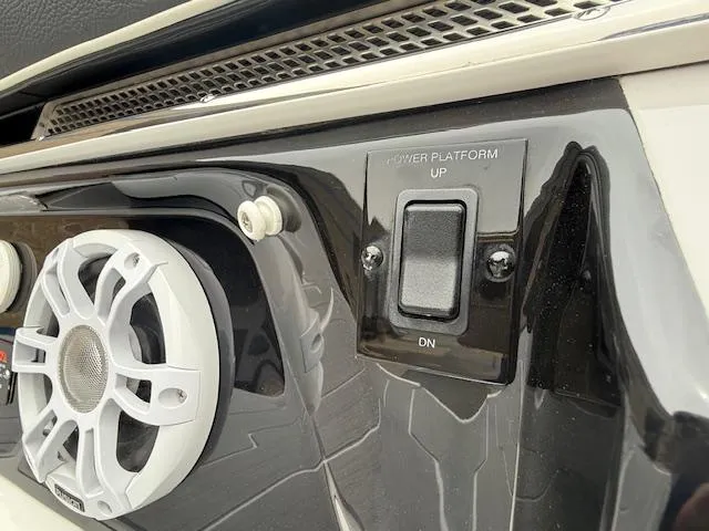 Slide: The Image of 2023 Regal LS6 boat control panel with speaker and power platform switch. - 39