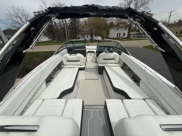 Slide: The Image of 2023 Regal LS6 boat interior with luxurious white seating and sleek design. - 7