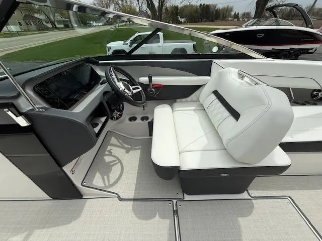 Slide: The Image of 2023 Regal LS6 boat interior with white seating and modern dashboard design. - 8