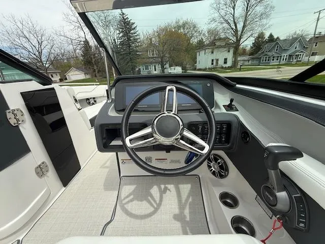 Slide: The Image of 2023 Regal LS6 boat cockpit with steering wheel and control panel. - 9