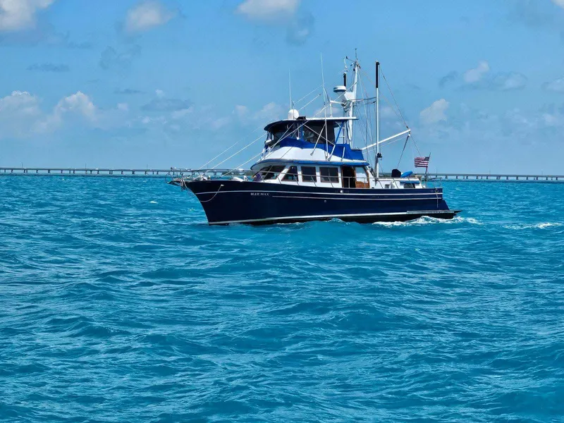 Slide: The Image of 1981 Albin 45 Command Bridge yacht cruising on blue ocean waters. - 11
