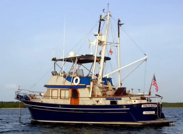 Slide: The Image of 1981 Albin 45 Command Bridge yacht on calm water, featuring classic design and American flag. - 12