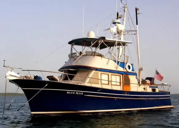 Slide: The Image of 1981 Albin 45 Command Bridge yacht on water, displaying American flag. - 14