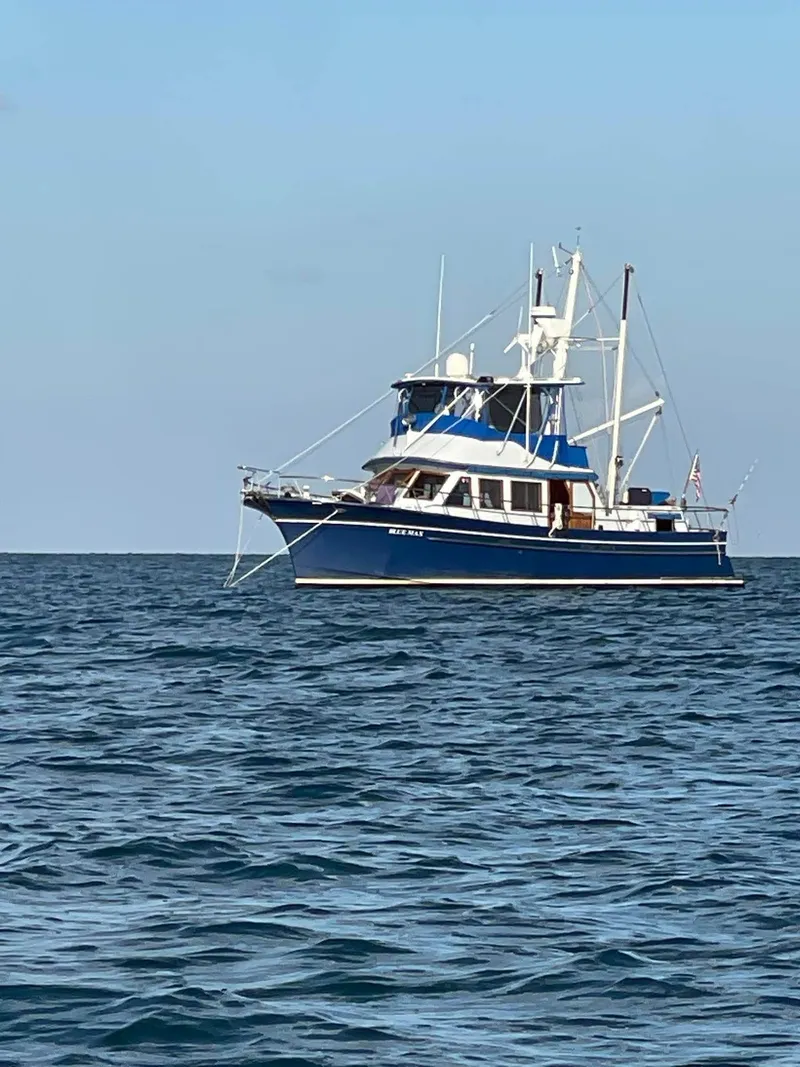 Slide: The Image of 1981 Albin 45 Command Bridge yacht on calm ocean waters. - 16