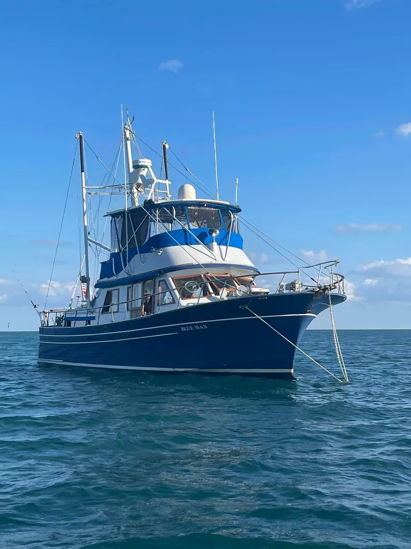 Slide: The Image of 1981 Albin 45 Command Bridge yacht on open water under clear blue sky. - 18