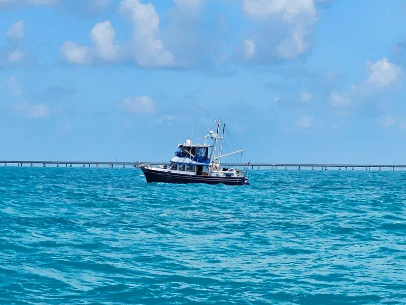 Slide: The Image of 1981 Albin 45 Command Bridge boat on blue ocean under cloudy sky. - 21
