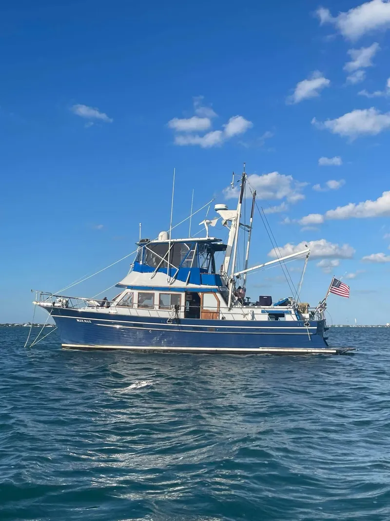 Slide: The Image of 1981 Albin 45 Command Bridge yacht on open water under clear blue sky. - 22