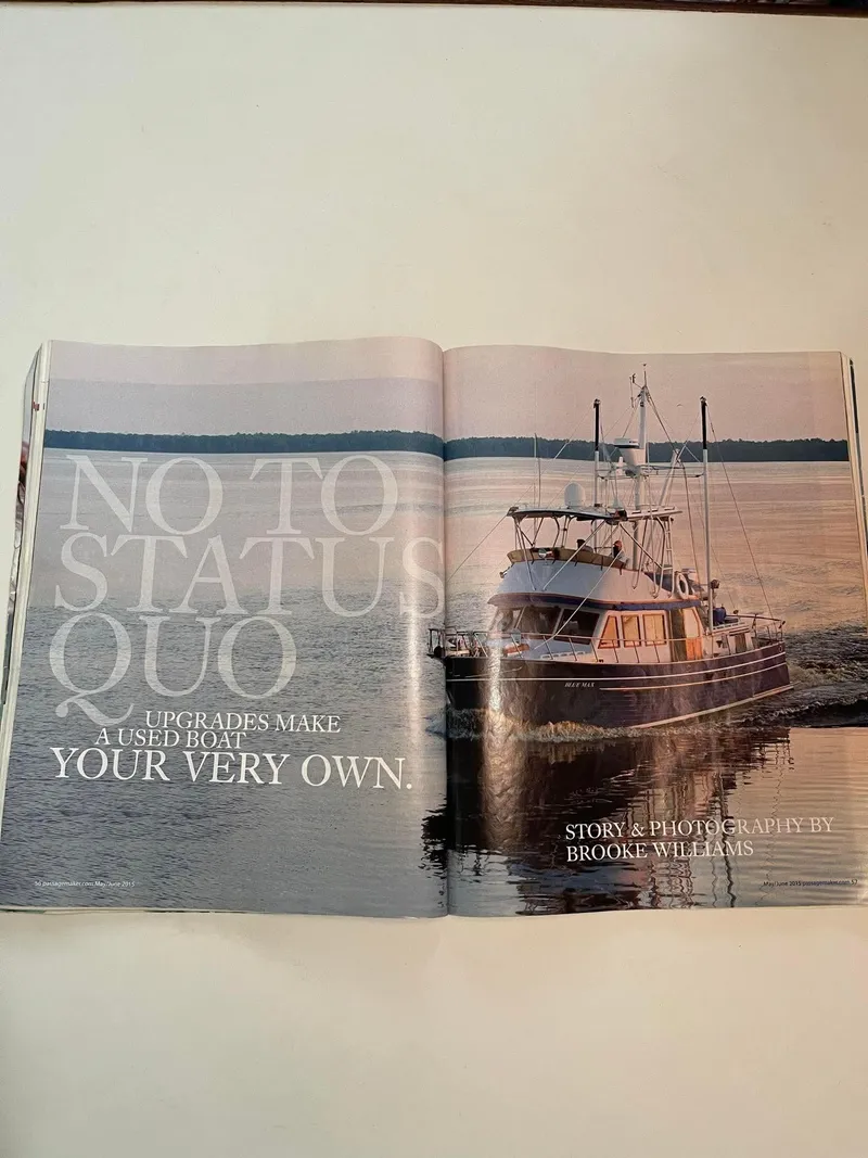 Slide: The Image of 1981 Albin 45 Command Bridge cruising on calm waters at sunset, featured in a magazine spread. - 23