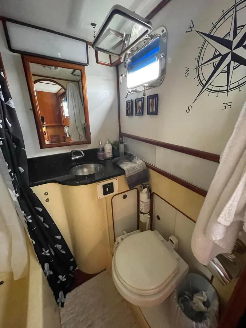 Slide: The Image of 1981 Albin 45 Command Bridge bathroom with nautical decor and modern amenities. - 28