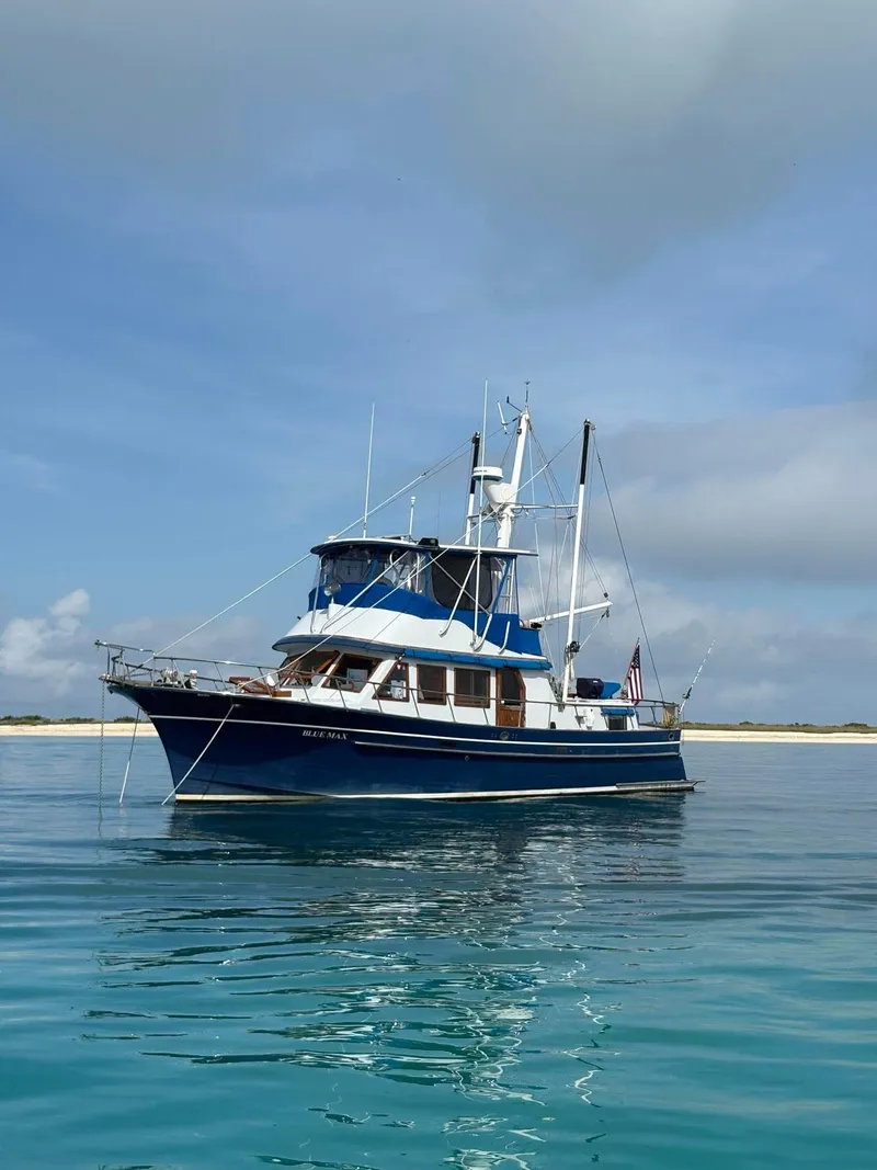 Slide: The Image of 1981 Albin 45 Command Bridge yacht on calm blue water under a cloudy sky. - 29