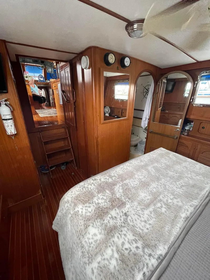 Slide: The Image of Interior of 1981 Albin 45 Command Bridge with wood paneling and cozy bed. - 3