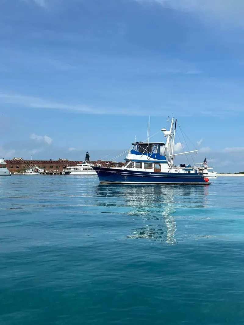 Slide: The Image of 1981 Albin 45 Command Bridge yacht on calm blue water under clear sky. - 30