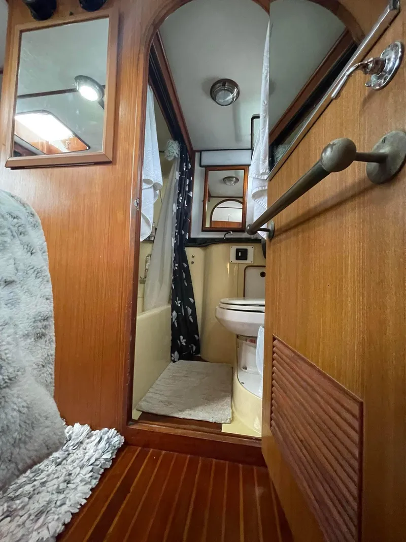 Slide: The Image of 1981 Albin 45 Command Bridge bathroom interior with wood accents and nautical decor. - 34