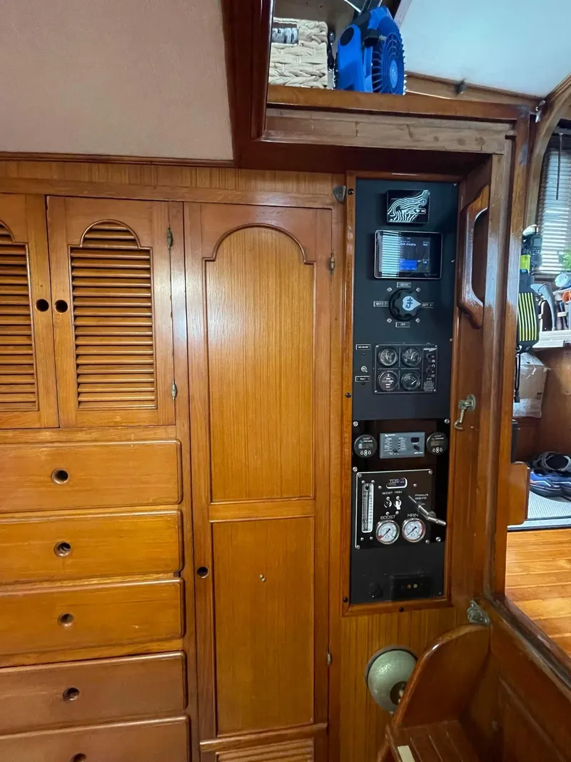 Slide: The Image of 1981 Albin 45 Command Bridge interior with wooden cabinetry and control panel. - 35