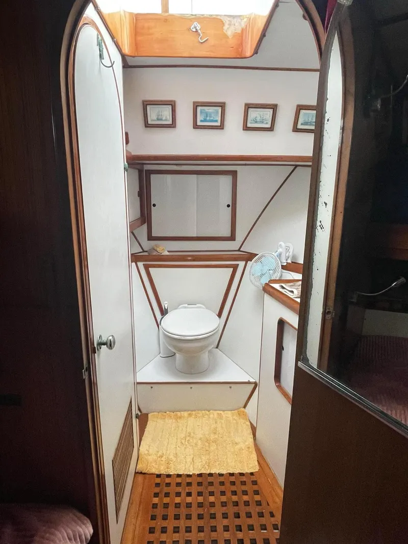 Slide: The Image of 1981 Albin 45 Command Bridge bathroom with nautical decor and wooden accents. - 37