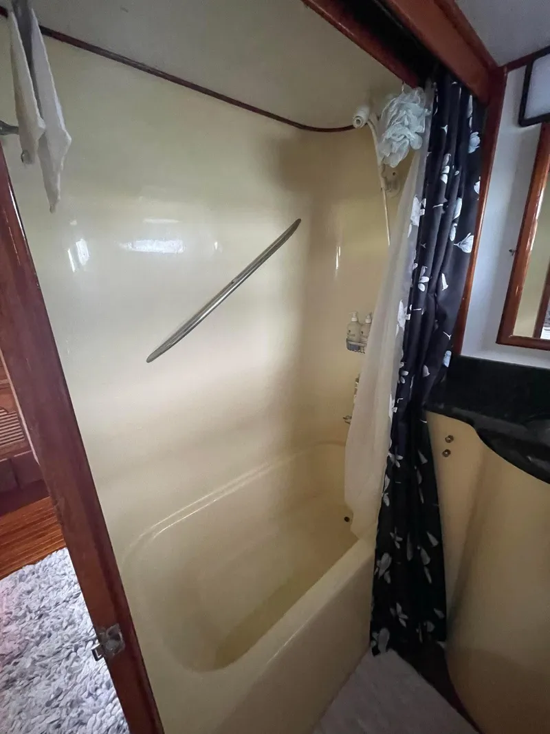 Slide: The Image of 1981 Albin 45 Command Bridge bathroom with shower and curtain. - 38