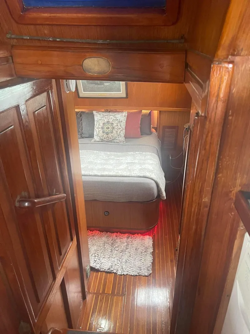 Slide: The Image of Cozy cabin interior of 1981 Albin 45 Command Bridge with wooden finish and plush bedding. - 42