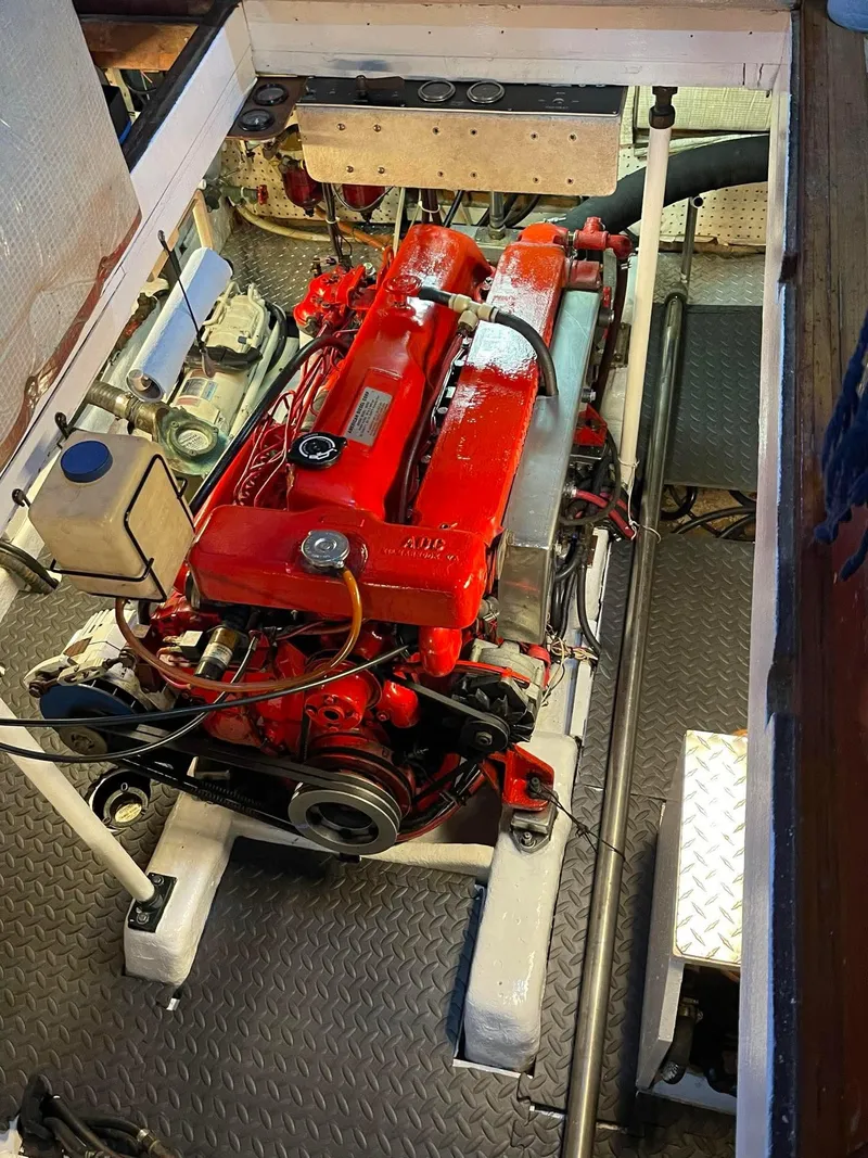 Slide: The Image of Engine room of 1981 Albin 45 Command Bridge with red engine components. - 46