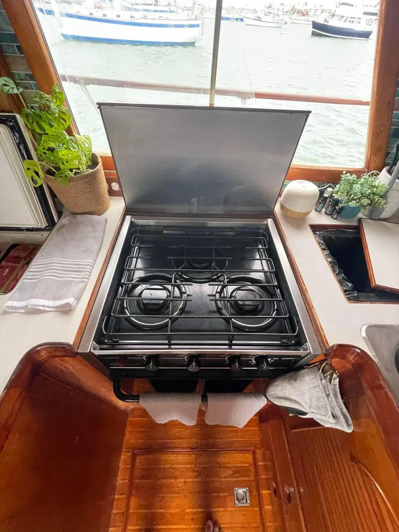 Slide: The Image of 1981 Albin 45 Command Bridge kitchen with stove, plants, and sea view. - 47