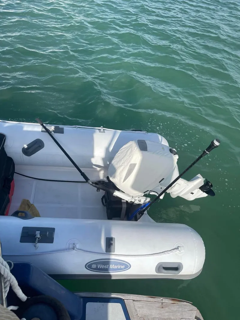 Slide: The Image of Inflatable boat with motor on water, near Albin 45 Command Bridge, 1981 model. - 5