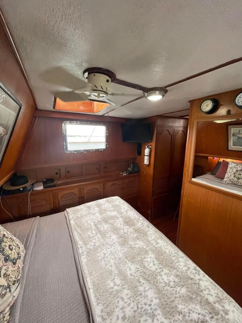 Slide: The Image of Interior of 1981 Albin 45 Command Bridge with cozy bedroom and wooden furnishings. - 6