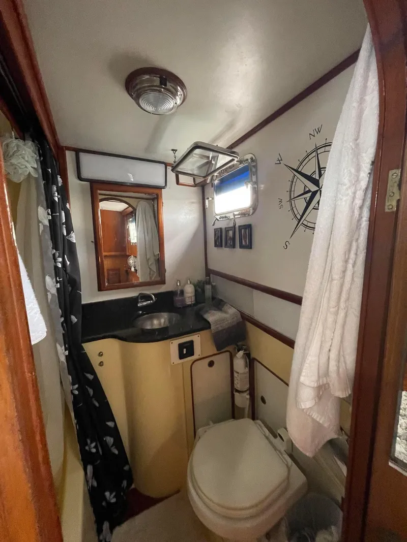 Slide: The Image of 1981 Albin 45 Command Bridge bathroom with nautical decor and compact amenities. - 7