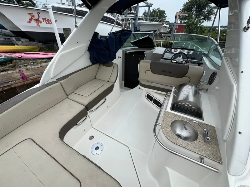 Slide: The Image of 2015 Sea Ray 280 Sundancer interior with seating, helm, and sink. - 36