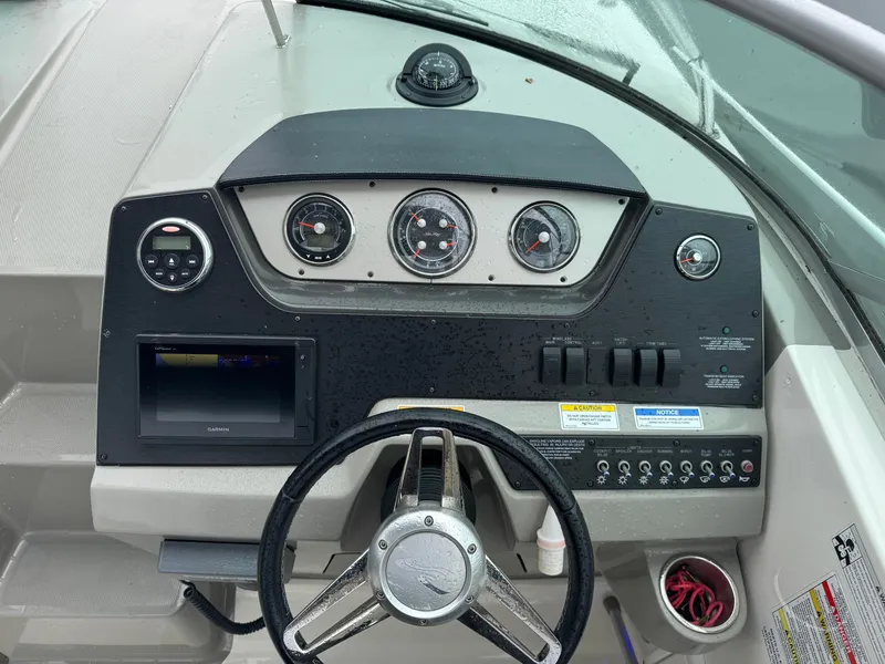 Slide: The Image of 2015 Sea Ray 280 Sundancer dashboard with gauges and controls. - 39