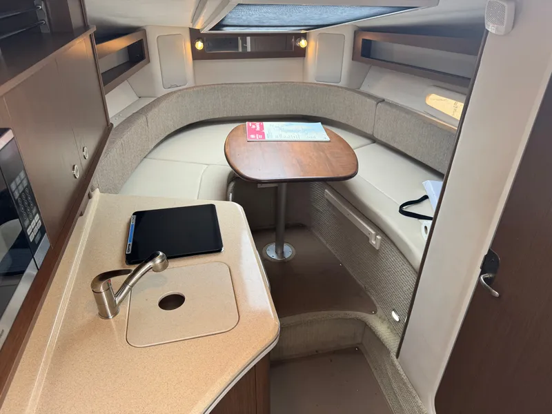Slide: The Image of 2015 Sea Ray 280 Sundancer cabin interior with kitchenette and seating area. - 41