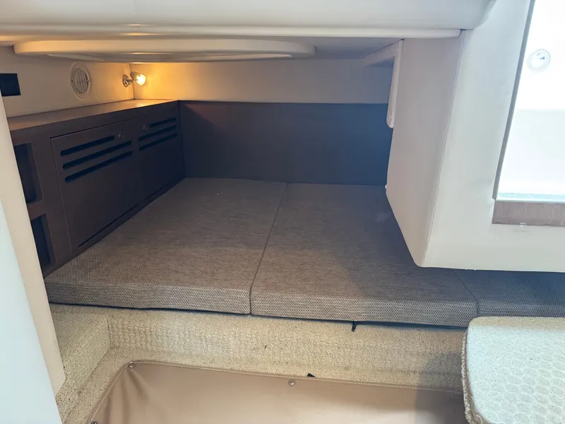 Slide: The Image of 2015 Sea Ray 280 Sundancer cabin interior with cozy sleeping area and ambient lighting. - 44