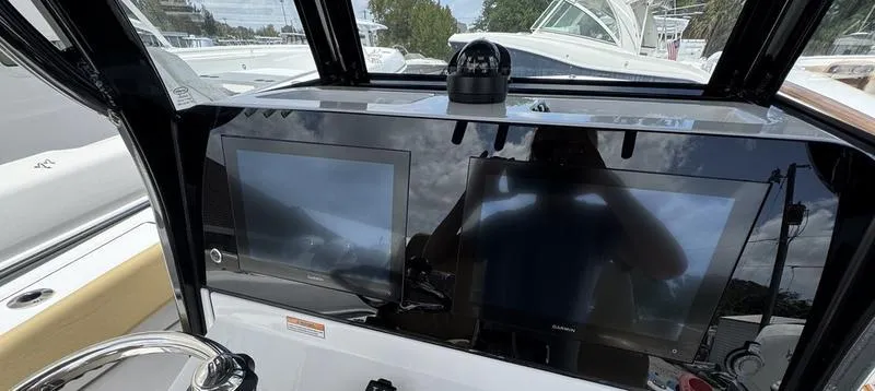 Slide: The Image of Dashboard of a 2025 Sportsman Heritage 261 boat with dual screens and navigation equipment. - 10