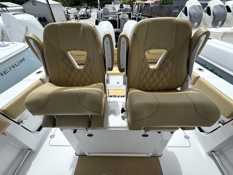 Slide: The Image of 2025 Sportsman Heritage 261 boat seats, tan leather, diamond stitching, dual helm chairs. - 11