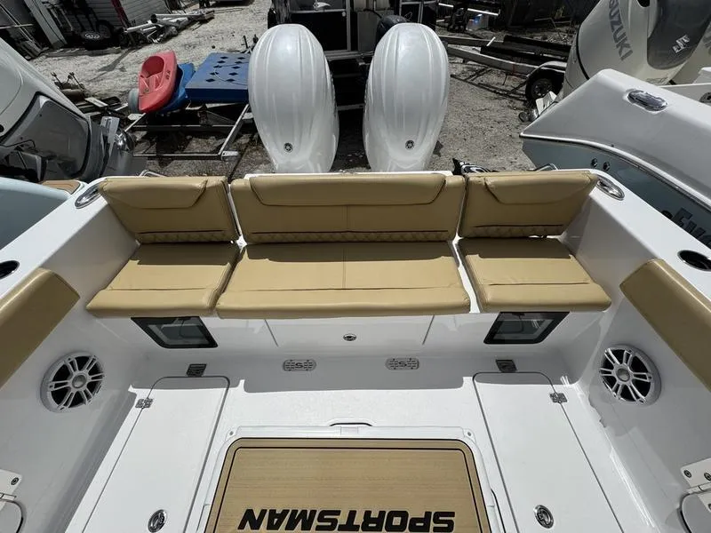 Slide: The Image of 2025 Sportsman Heritage 261 boat interior with beige seating and twin outboard motors. - 13