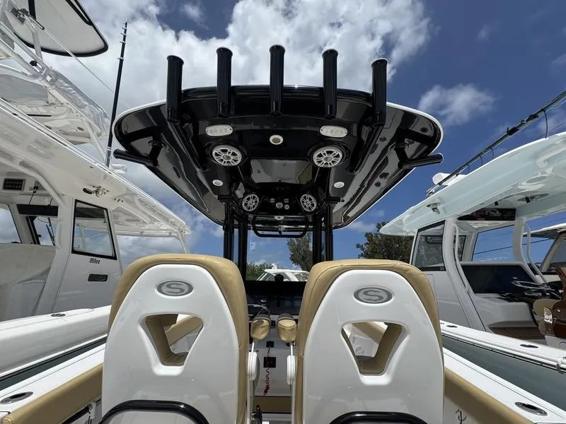 Slide: The Image of 2025 Sportsman Heritage 261 boat interior with dual seats and overhead rod holders. - 14