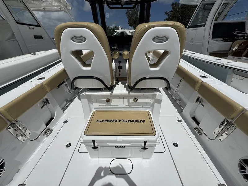 Slide: The Image of 2025 Sportsman Heritage 261 boat interior with dual seats and branded cooler. - 15
