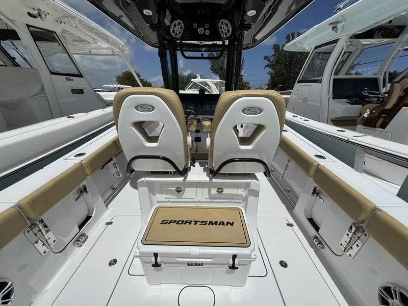 Slide: The Image of 2025 Sportsman Heritage 261 boat interior with tan seating and modern design. - 16