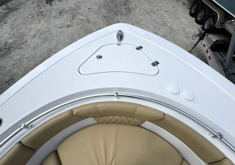 Slide: The Image of 2025 Sportsman Heritage 261 boat bow with tan seating and storage compartment. - 7