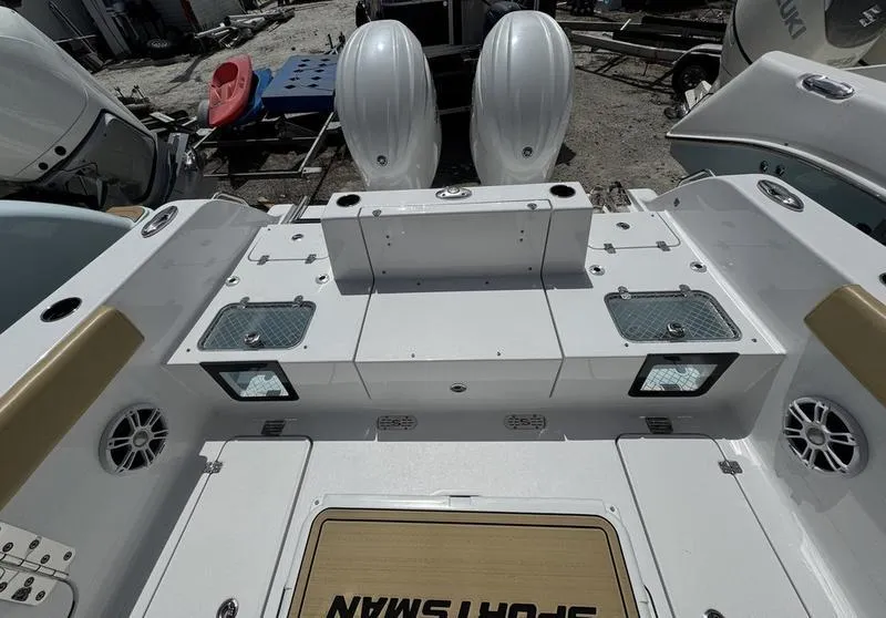 Slide: The Image of 2025 Sportsman Heritage 261 boat deck with dual engines and storage compartments. - 9