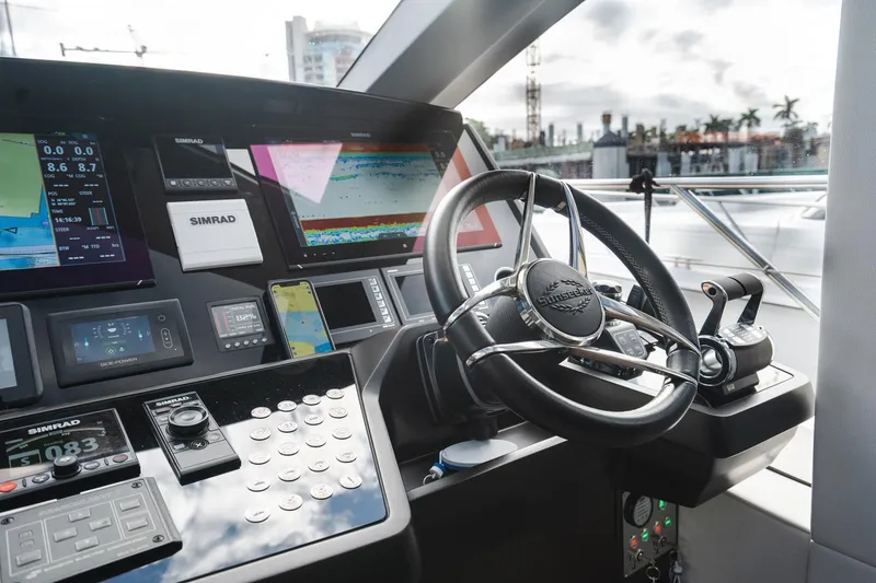 Slide: The Image of Control panel of 2020 Sunseeker 74 Predator yacht with advanced navigation systems and steering wheel. - 11
