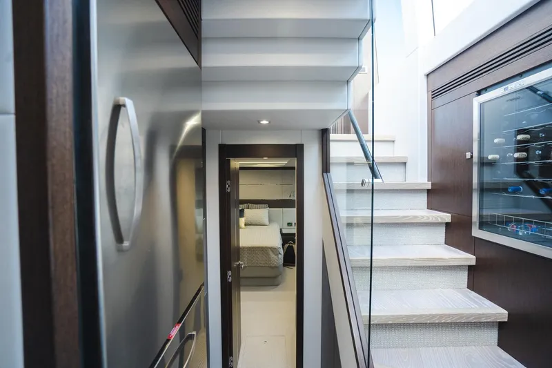 Slide: The Image of Interior of 2020 Sunseeker 74 Predator yacht, featuring modern staircase and cozy cabin entrance. - 13