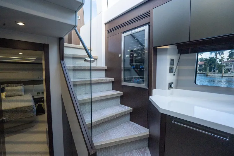 Slide: The Image of Interior of 2020 Sunseeker 74 Predator yacht, featuring modern staircase and sleek kitchen design. - 15