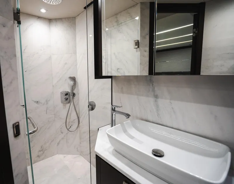 Slide: The Image of Luxurious bathroom in 2020 Sunseeker 74 Predator yacht, featuring modern fixtures and marble design. - 30