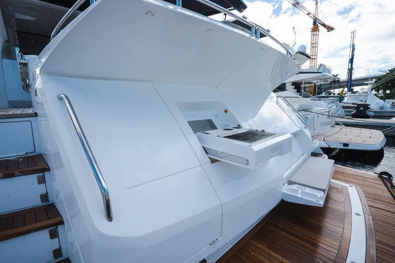 Slide: The Image of Sunseeker 74 Predator 2020 yacht stern with sleek design and wooden deck. - 41