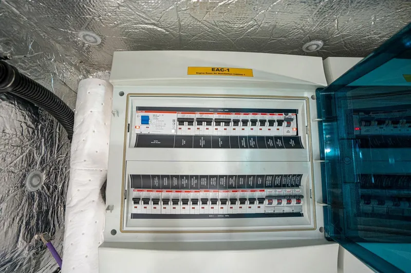 Slide: The Image of Electrical panel inside 2020 Sunseeker 74 Predator yacht, showcasing circuit breakers and wiring. - 47